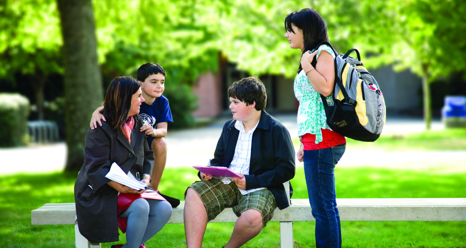 Family walking and talking on campus